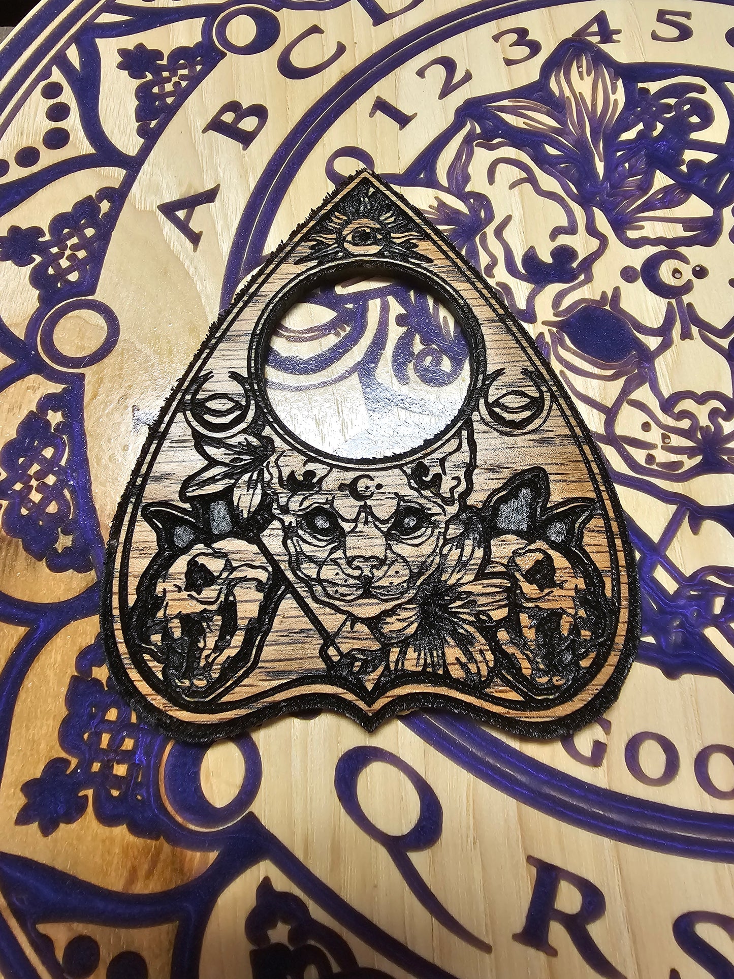 Mystic cat Ouija board with matching planchette.